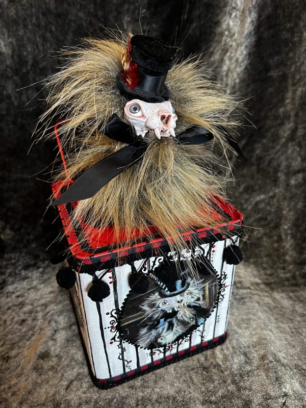 hand-painted gothic mixed media jack in the box assemblage with a furry skull-faced weasel wearing a top hat and box