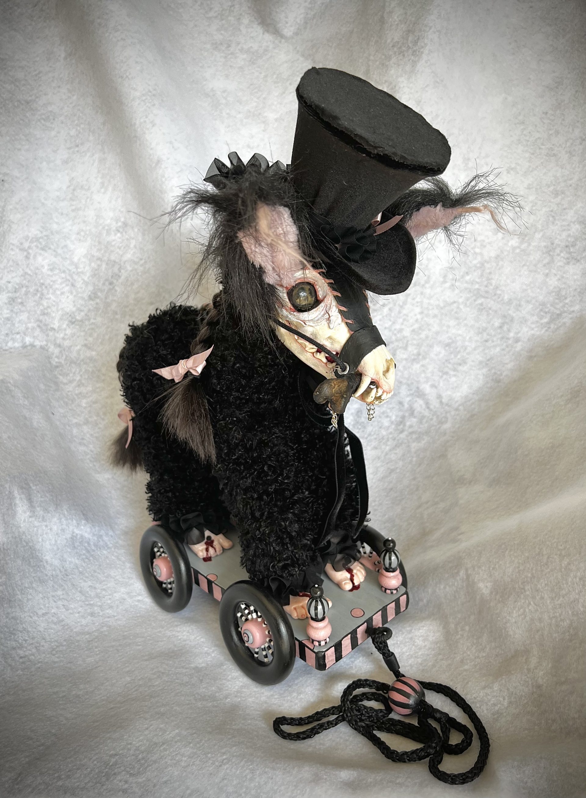 handmade pulltoy with a gothic furry creature with fox skull head and velvet tophat