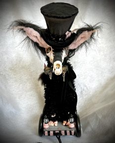 handmade pulltoy with a gothic furry creature with fox skull head and velvet tophat