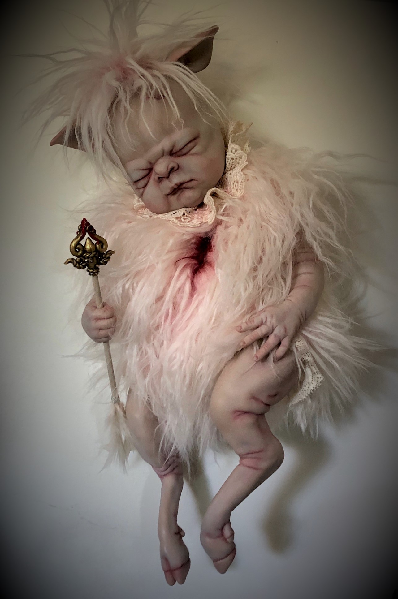 mixed media artdoll hybrid lamb babydoll with hand-painted vinyl head light pink faux fur, lamb legs, baby clutches the arrow that mortally wounded her bloody chest