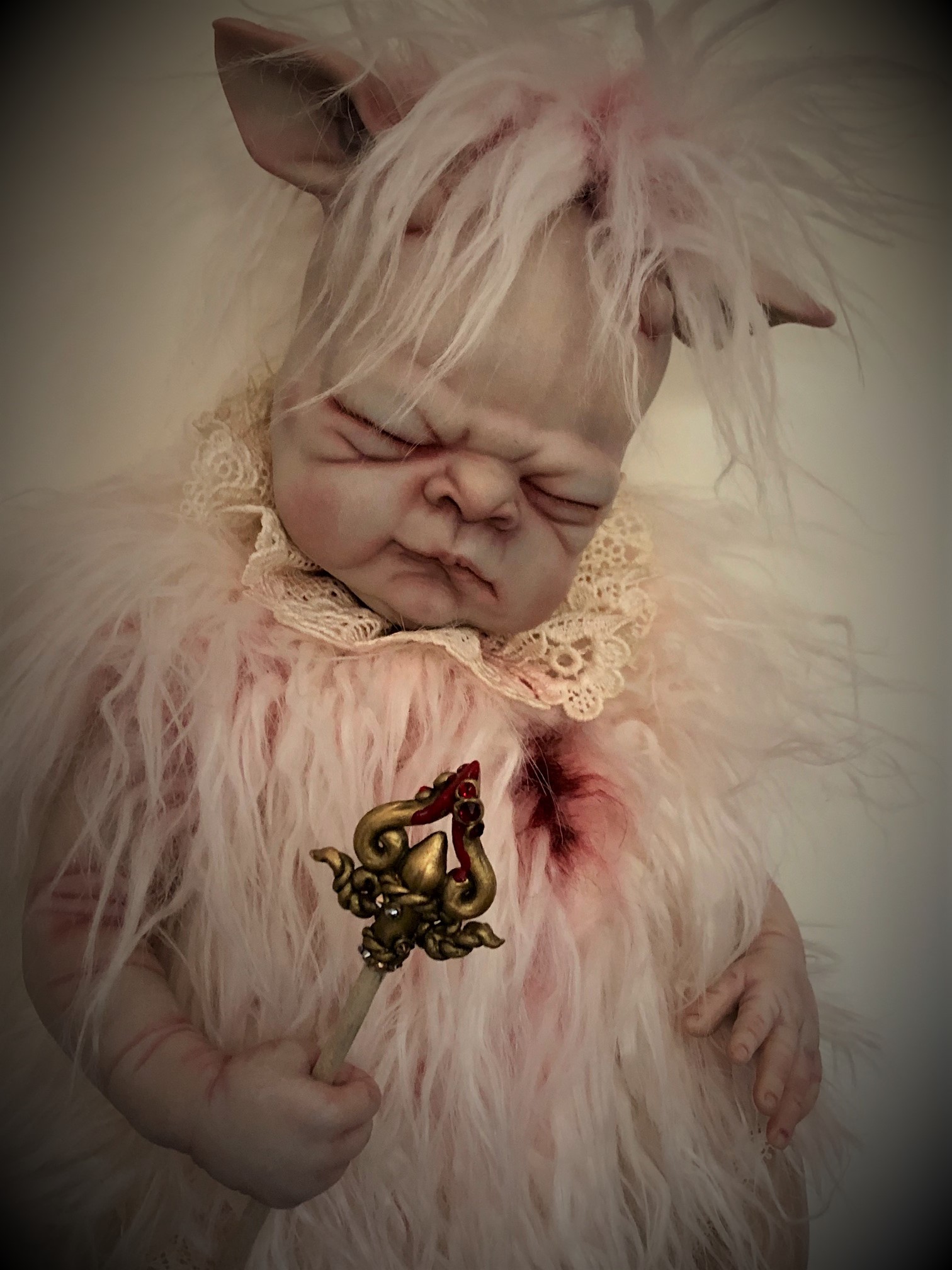 mixed media artdoll hybrid lamb babydoll with hand-painted vinyl head light pink faux fur, baby clutches the arrow that mortally wounded her bloody chest