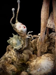 extreme close-up mixed media art assemblage sculpture enchanting snail-like fairy creature on forest floor