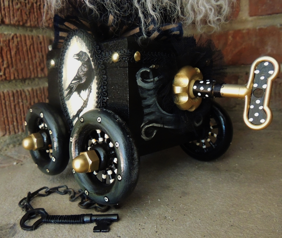 close-up of goth wind-up pull-car toy with raven painted on the side
