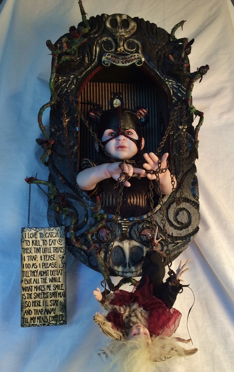 gothic artdoll wearing black leather cat mask holds chained smaller bird artdoll from inside her carved shadowbox hand-painted letter sign