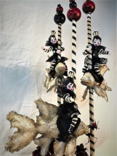 mixed media striped three miniature gothic sprites circus performers wearing black and white ride carousel fish