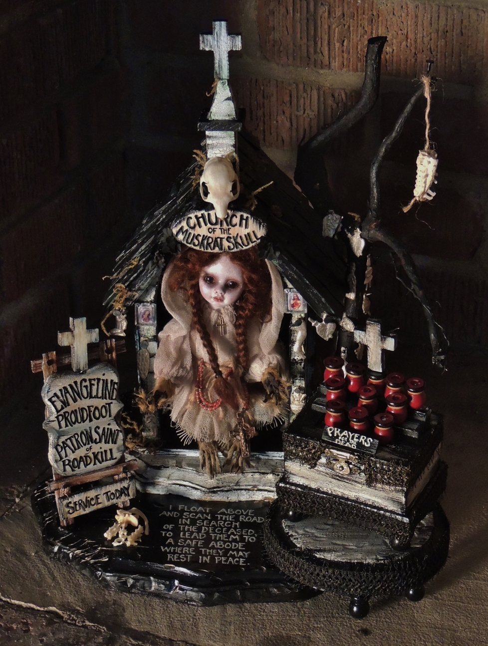 miniature mixed media taxidery assemblage of an altarpiece doll representing the Patron Saint of Roadkill