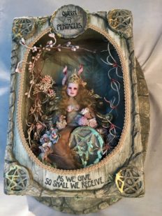 diorama shadowbox tableau of miniature queen artdoll sitting with a pentacle in a carved box