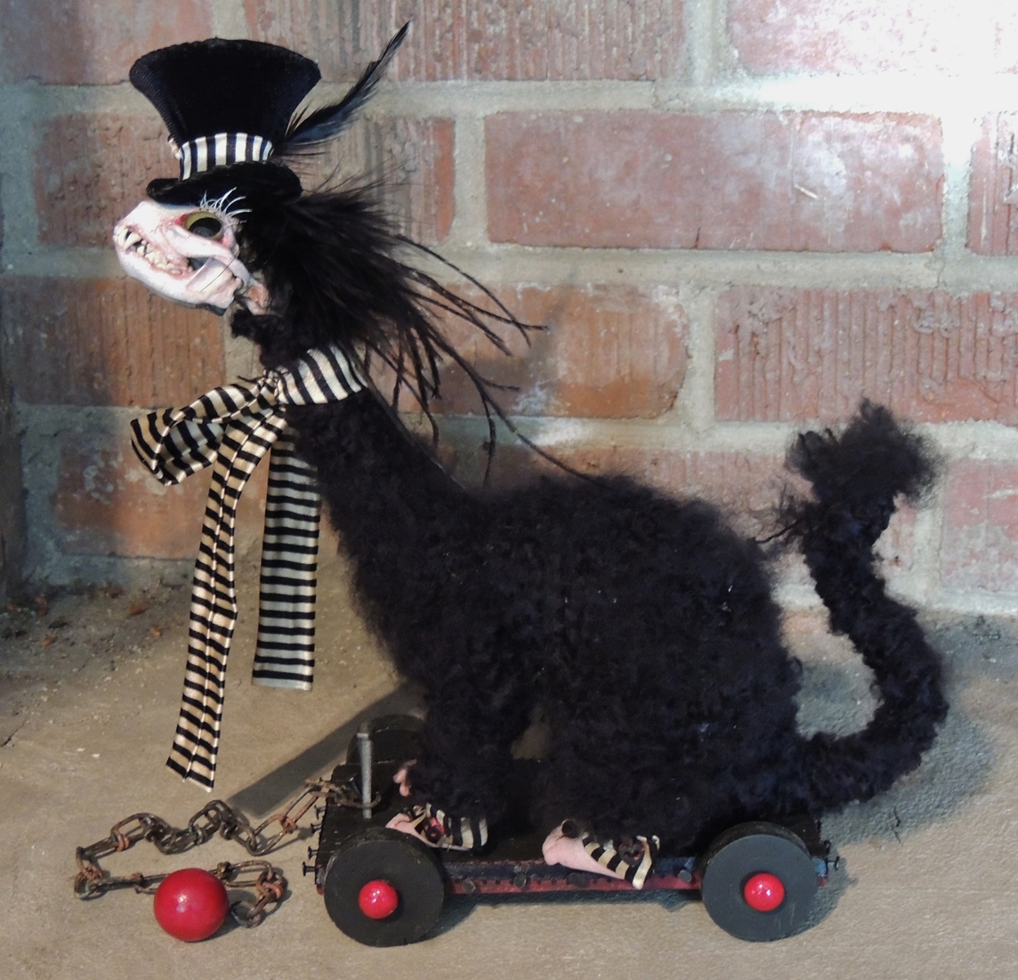 sideview gothic victorian dandy black furry fantasy animal creature with real skull head and doll feet wearing a top hat and a black and white striped ribbon standing on a black and red wooden cart