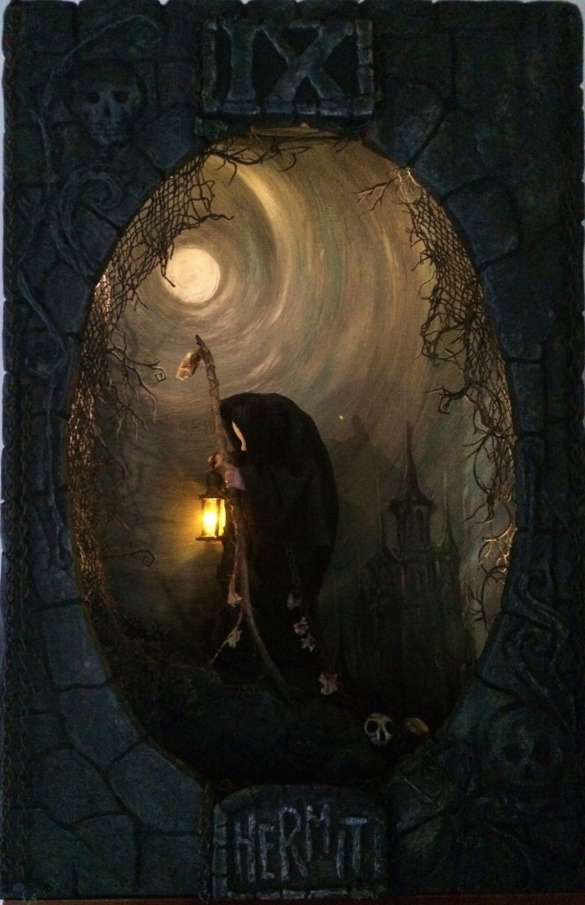 miniature shadowbox diorama of a shadowy tiny artdoll hermit figure in a cloak with a walking stick walking in a handpainted moonlit night scene
