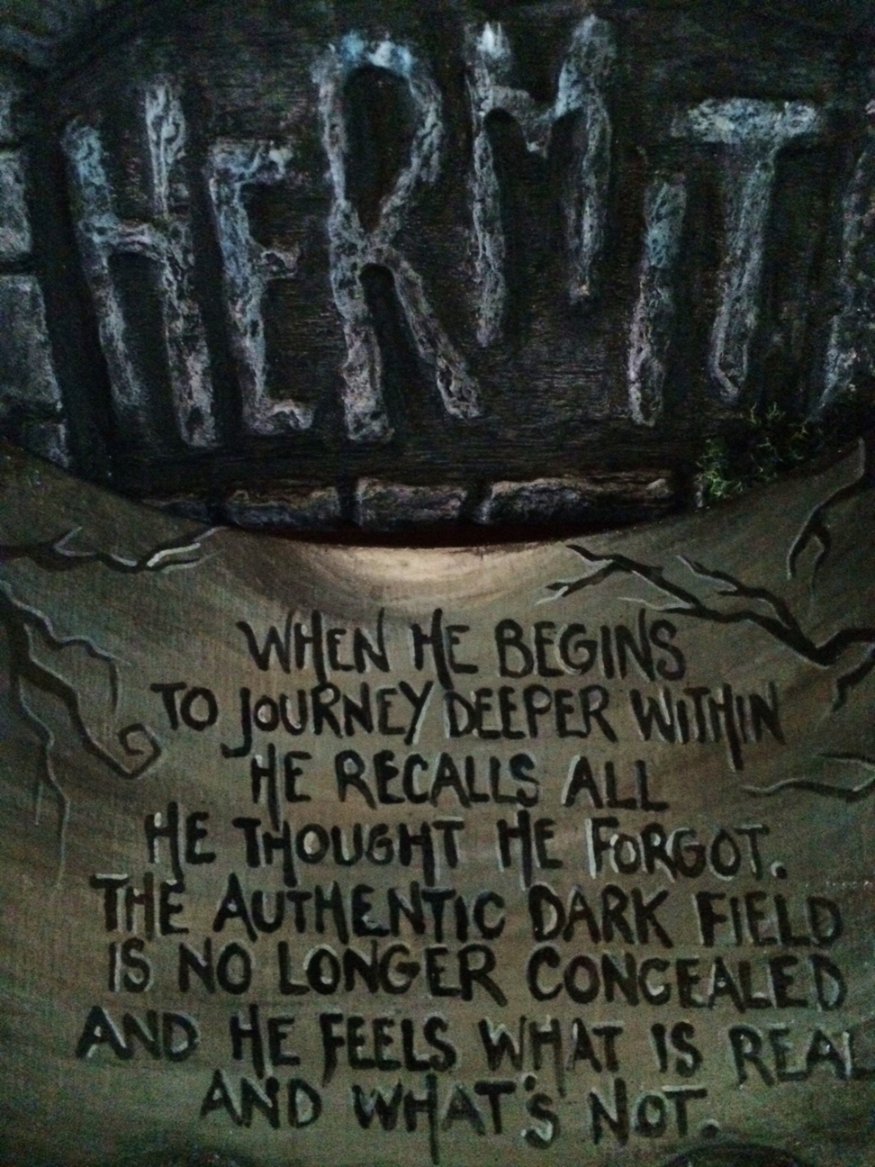 hand-painted lettered wooden sign with verse about the Hermit